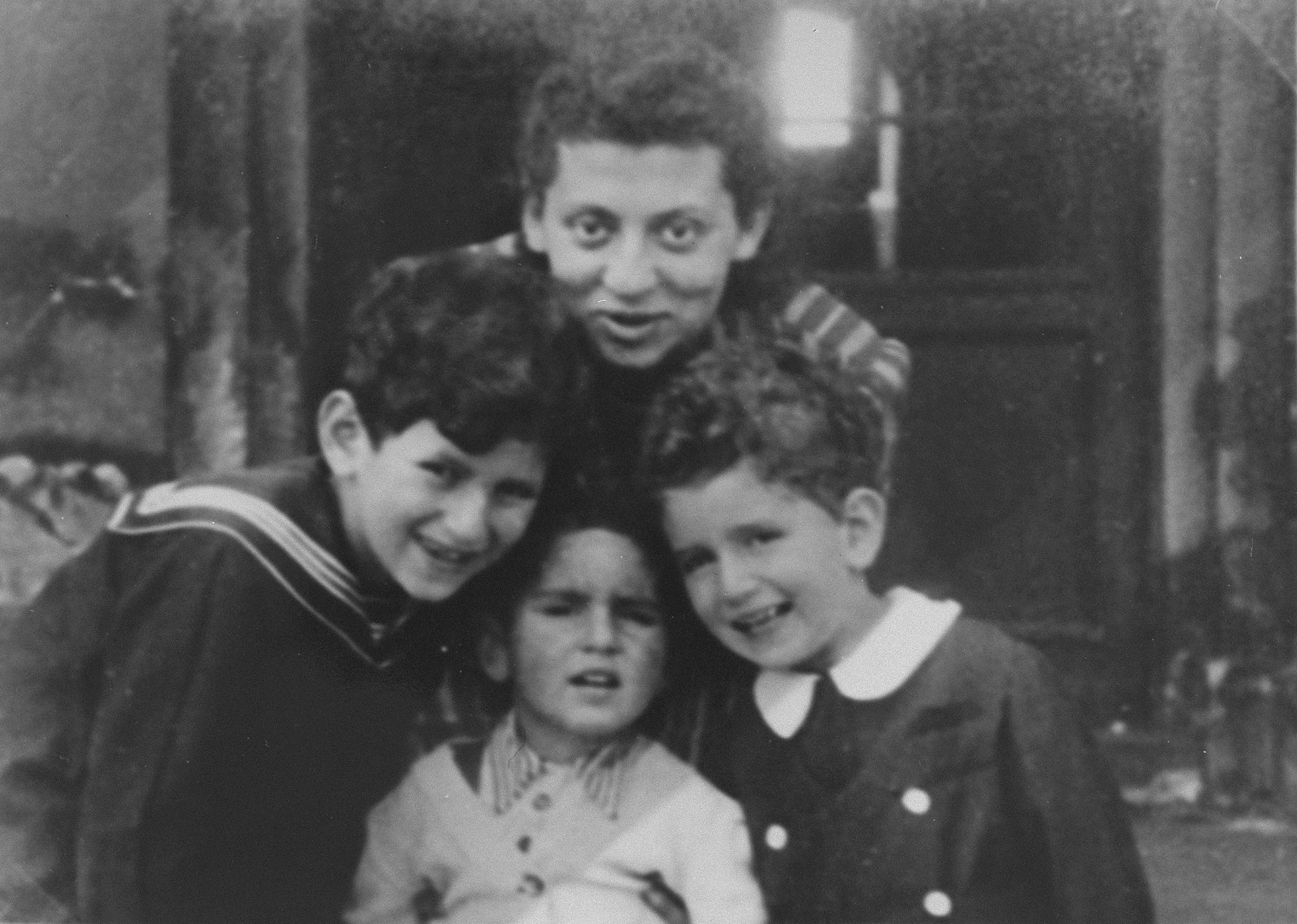 The three Gutgeld children pose with their aunt in the Warsaw Ghetto, prior to their being placed in hiding with Alex and Mela Roslan. 

Pictured are Jacob, David and Shalom Gutgeld with their Aunt Janke.
