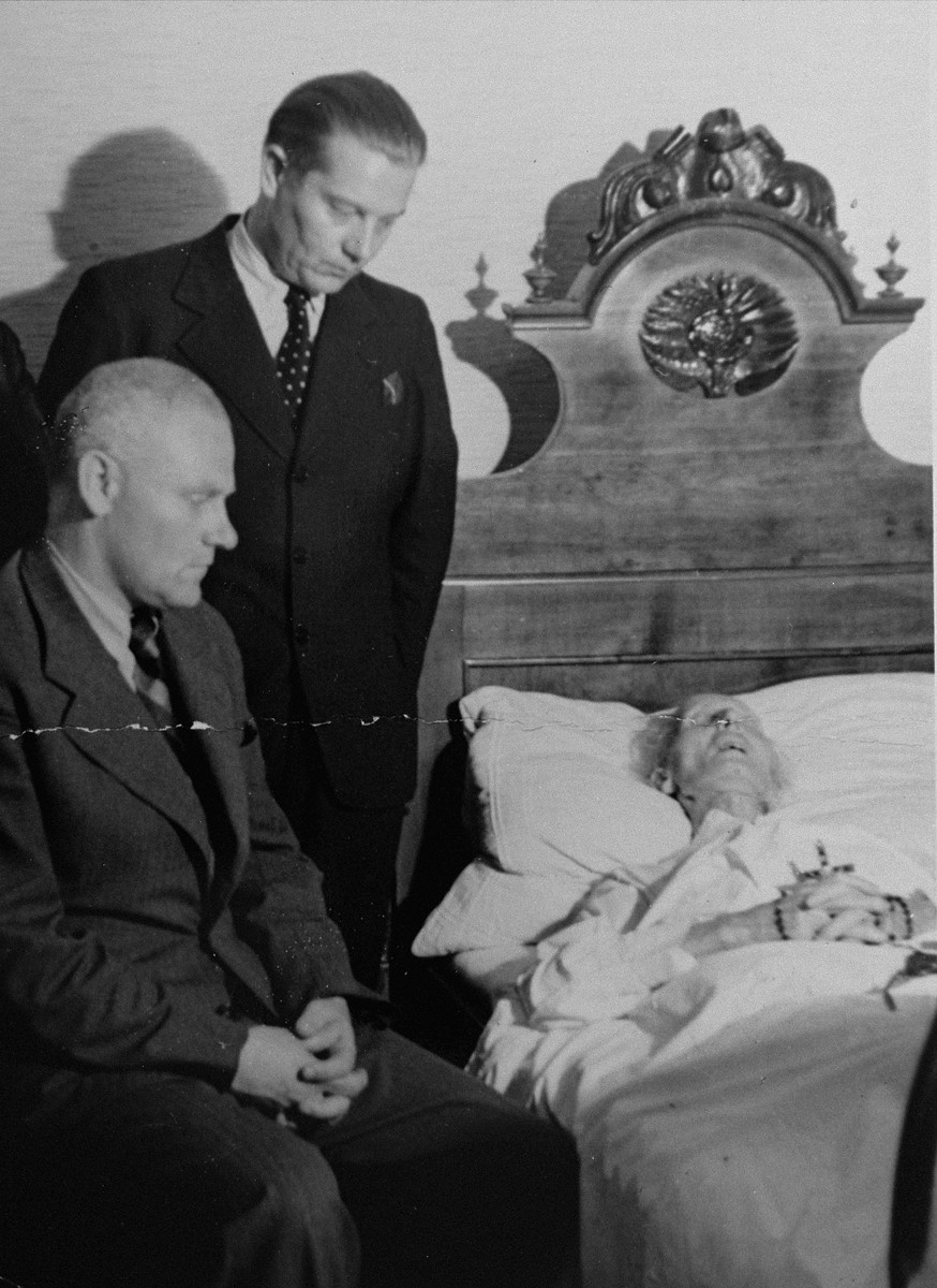 Dr. Joseph Jaksy (standing) tends to Andrej Hlinka on his deathbed.  He was honored posthumously by Yad Vashem as one of the Righteous Among the Nations.