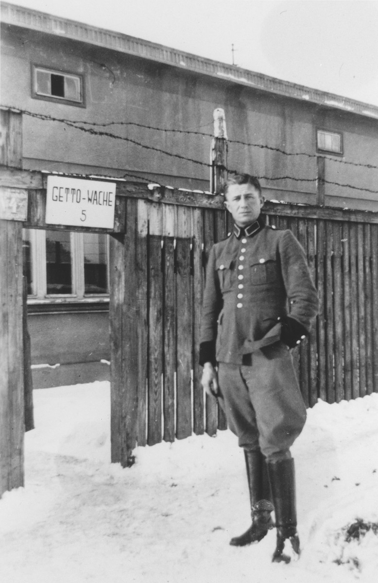 A member of Police Battalion 101 [probably Bernhardt Colberg] poses at the entrance of guard post #5 in the Lodz ghetto.

One image from a photograph album belonging to a member of Police Battalion 101.