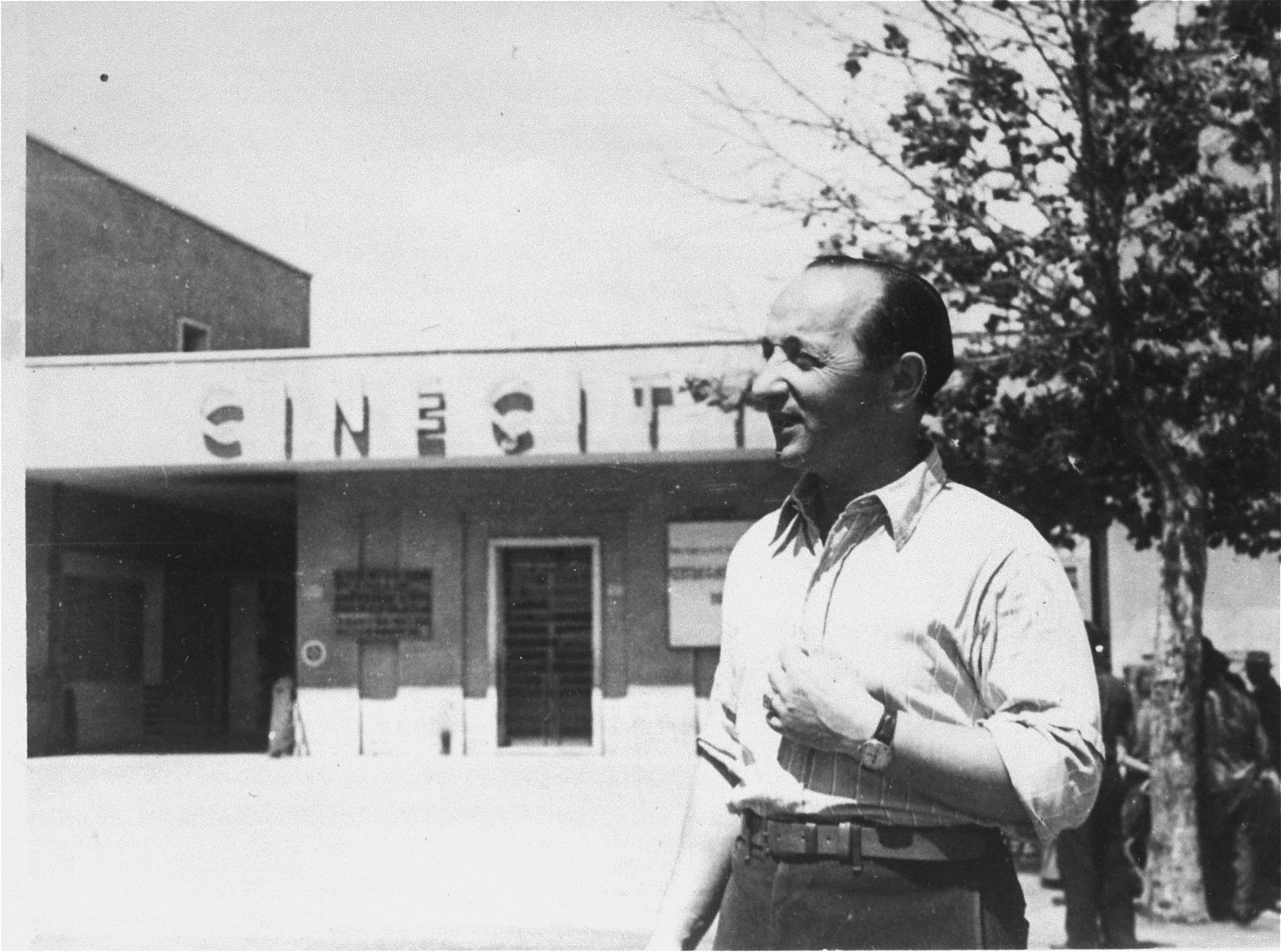 A Jewish DP poses at the entrance to the Cinecitta displaced persons camp in Rome.

Pictured is Edward Arzt.