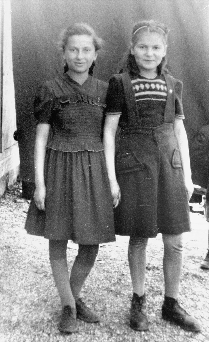 Frima Gleiser (right) and a friend stand outside a barrack in the Pocking (Schlupfing) displaced persons camp.