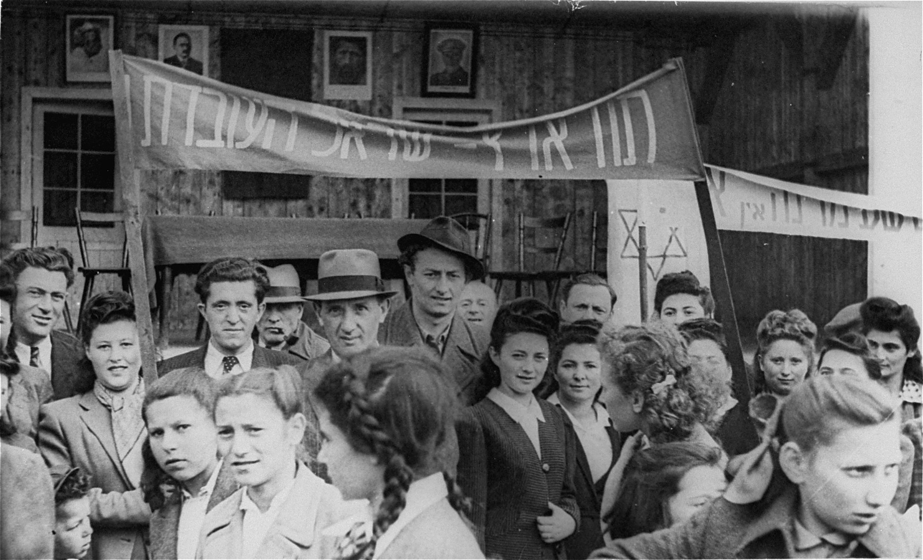 Jewish DPs participate in a demonstration calling for unrestricted immigration to Palestine at the Neu Freimann displaced persons camp.

The second person from the left is Lilly Scherb (maiden name, Kleidermacher, who was the aunt of Aaron Elster. The little boy just below her elbow is her baby brother who later was run over by a truck and killed in the camp. The young ladies in front were fellow schoolmates of Aaron.