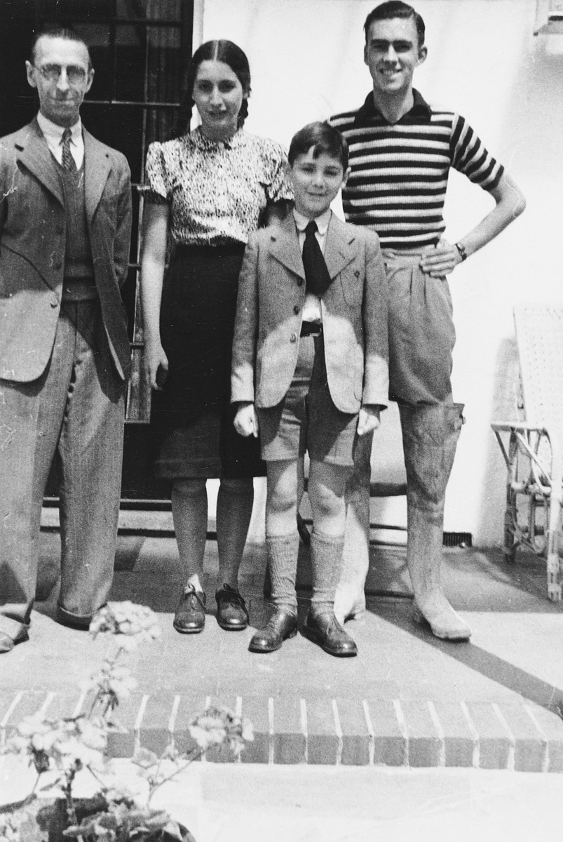 Elisabeth and Lux Adorno pose with Mr. Hulford, their first foster-parent after arriving in England on a Kindertransport.