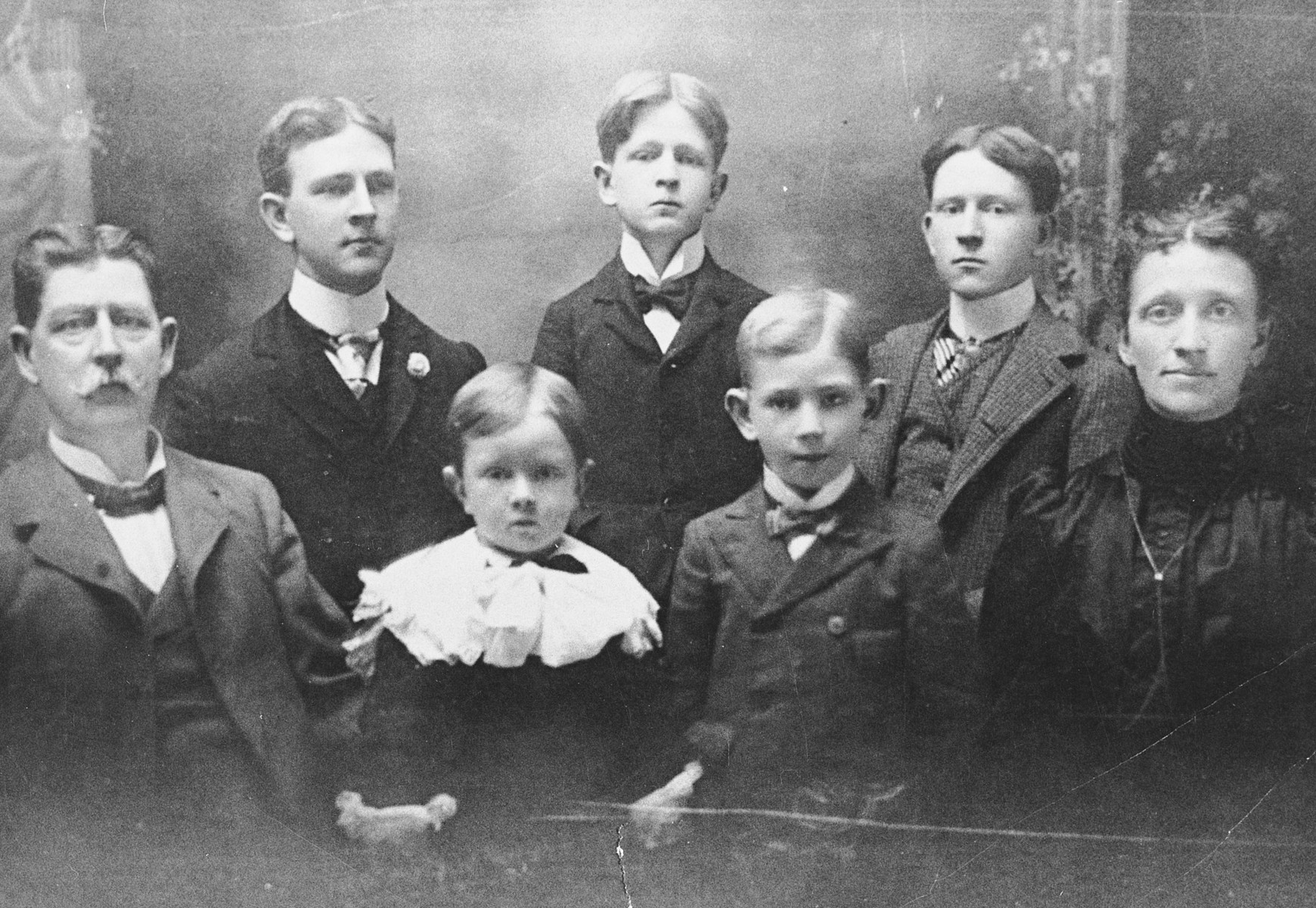 Studio portrait of the family of James G. McDonald, including his parents and four siblings.

Pictured in the front row from left to right are: Kenneth (father), William, Edward, and Anna (Dietrick) McDonald (mother).  In the back row are: John, James, and Joseph McDonald.