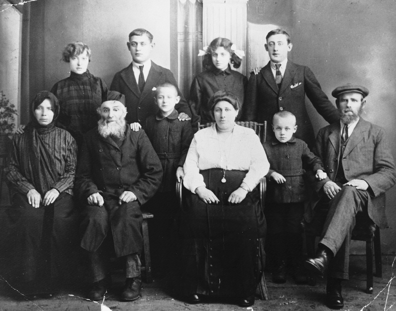Studio portrait of the extended Fleisher family of Kursenai Lithuania.

Front left to right: great-aunt of the donor, Grandfather Shmoel-Hirsh, Reuven-Leib, Tame-Dvora (mother of donor), Yehezkel and Shlomo David Fleisher (father of donor).  Back row: Batia Michaele, Zalman Lezer, Esther Raize and Haim Ber Fleisher.