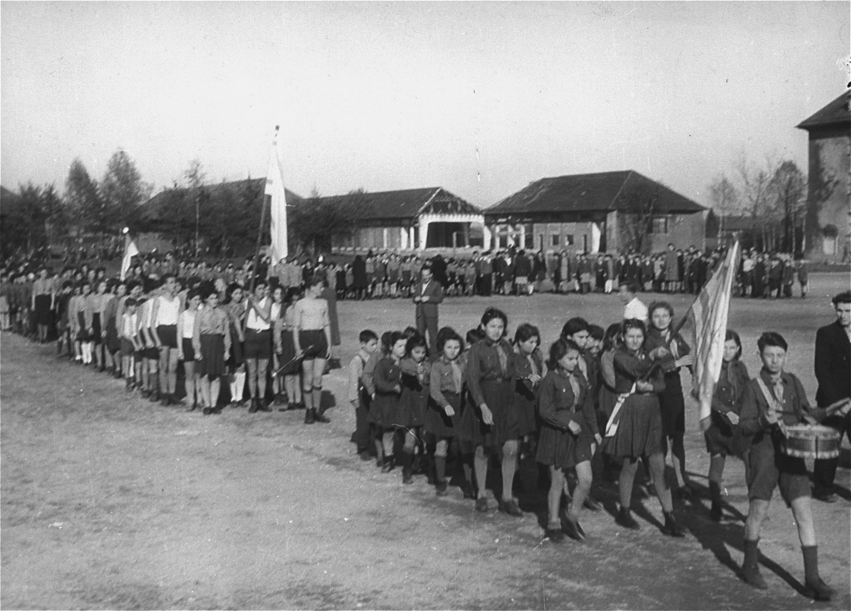 Zionist youth parade with flags around the central yard in the Landsberg displaced persons'camp.