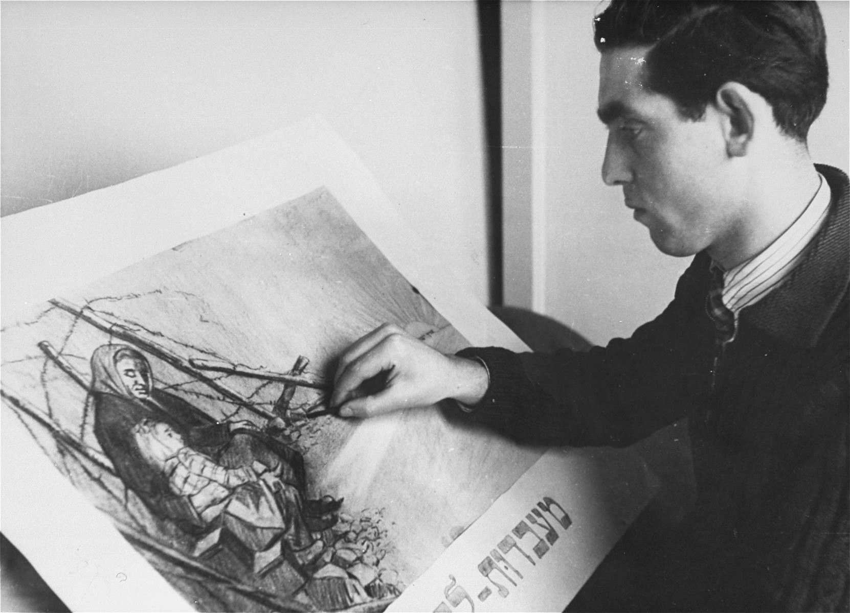 Metzger, a young artist in the Landsberg displaced persons' camp, works on a charcoal drawing entitled "From Slavery to Freedom."

The inscription written on the back of the photograph by George Kadish reads (translated from Yiddish), "A young artist in the camp."