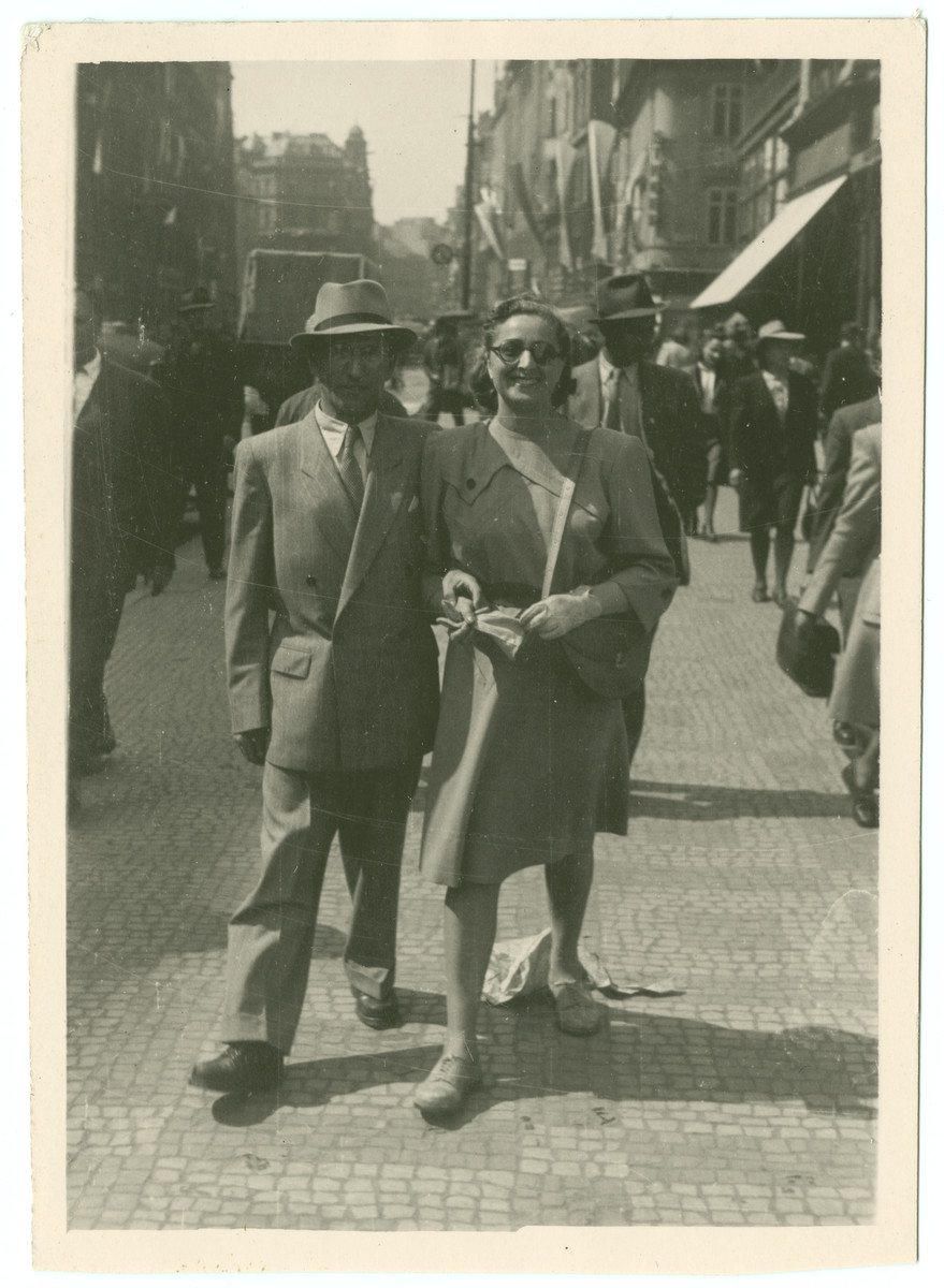 Rabbi and Mrs. Samuel Freilich walk down a street in Prague ...