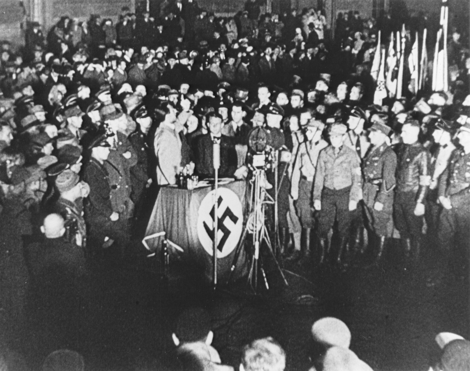 Reich Minister for Public Enlightenment and Propaganda, Joseph Goebbels, delivering a speech during the book burning on the Opernplatz. 

Still from a motion picture.