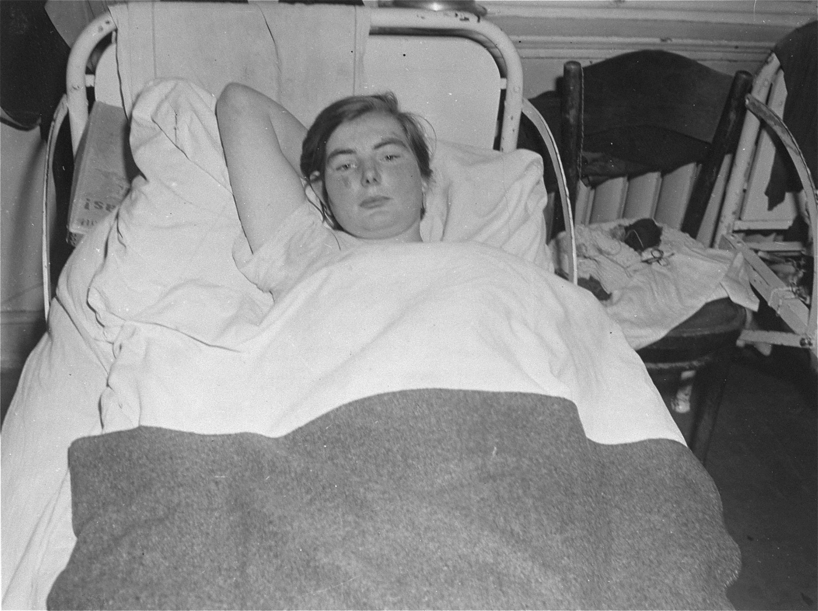 A female survivor lies in bed at the Hadamar Institute.

23-year-old Elizabeth Killiam, the mother of twins, was sterilized at a health care facility in Weilburg before being transferred to the Hadamar Institute.  The photograph was taken by an American military photographer soon after the liberation.