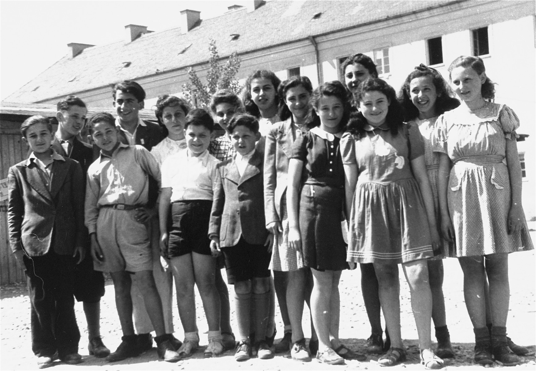 DP children in the Bindermichl DP camp.

Among those pictured is Pinja Blitt, the tallest boy in the back row, second from the left.  Also pictured is Tania Sendersky (front row, wearing a black dress).  She is the daughter of Eva and Ralph Sendersky of Kiev.  Pictured sixth from the right is Laura Chomut (Oberlander).  Seventh from the right (in back) is Leila Kornbluth.  Eighth from the right (in front, wearing short pants) is Tuli Bricks ( later  Dr. Nathan Bricks).