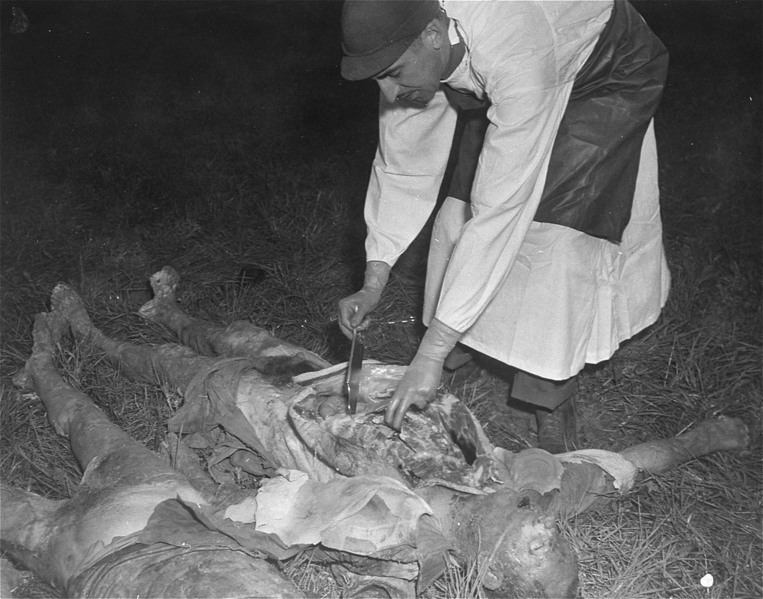Major Herman Bolker, a member of the war crimes investigation team, performs an autopsy on an exhumed Polish victim who was put to death at the Hadamar Institute.

The photograph was taken by an American military photographer soon after the liberation.