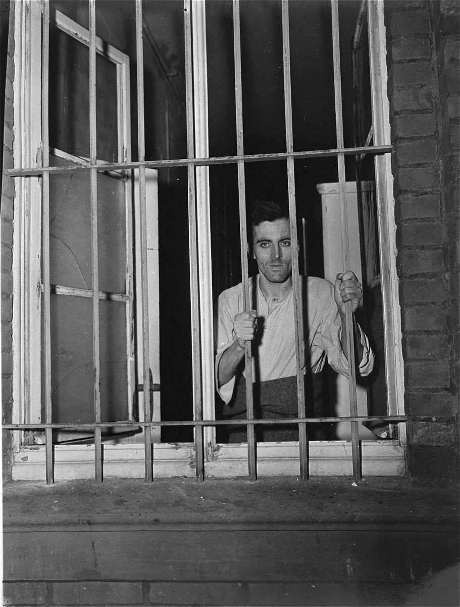 A survivor looks out a barred window at the Hadamar Institute.

The photograph was taken by an American military photographer soon after the liberation.