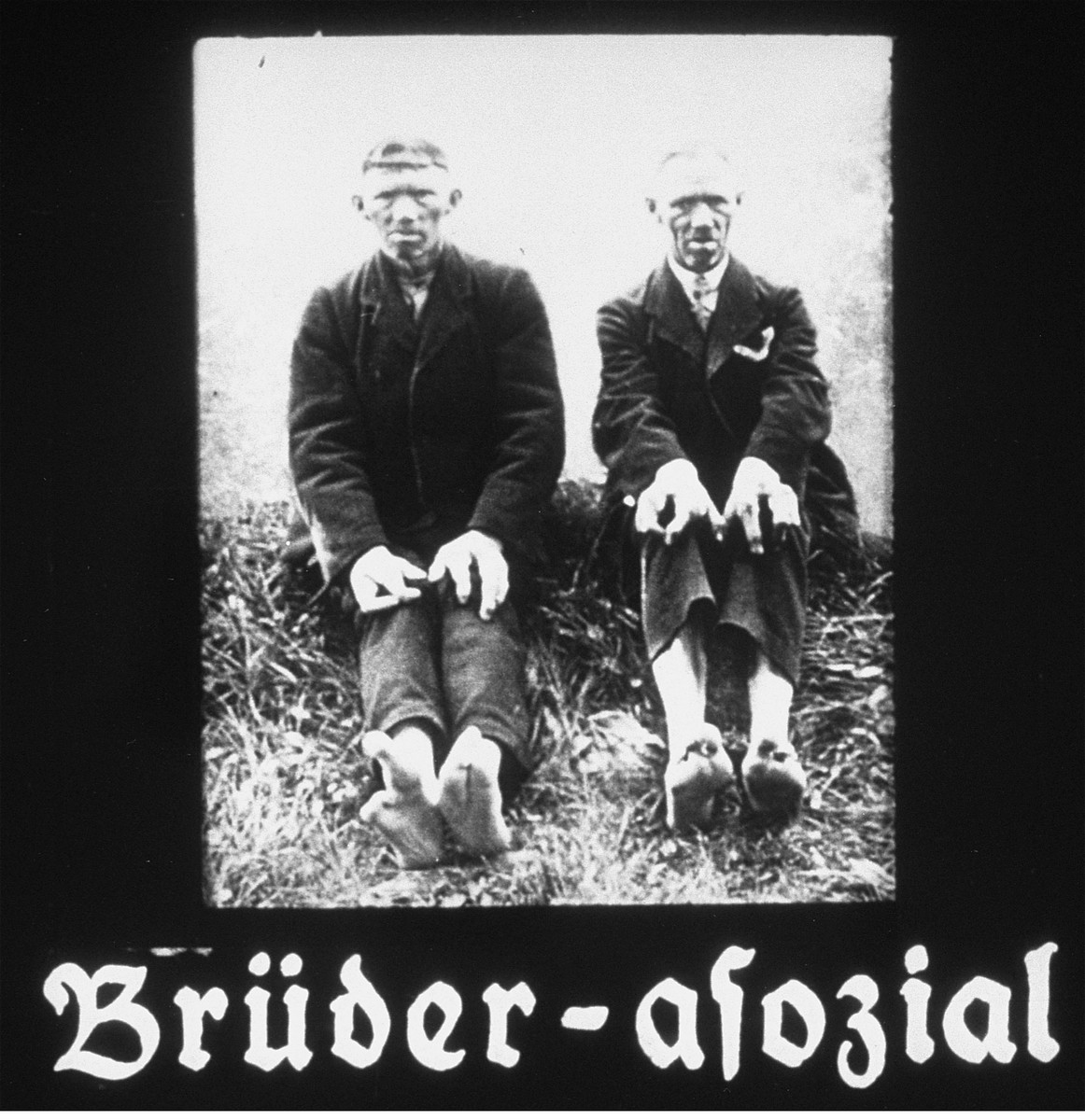 Propaganda slide featuring two disabled brothers sitting in the grass.  The caption reads, "Brothers-asocial."