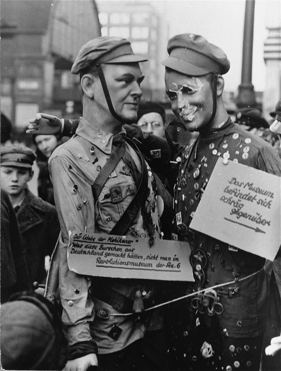 Two mannequins in the uniform of the Communist "Red Front" displayed in the Alexanderplatz as a promotion for the National Socialist Museum  of Revolution. 

The photo shows the two dolls with placards reading: "`The Last of the Mohicans': What these lads would have made out of Germany, is to be seen at the Museum of Revolution, of the Standard 6".