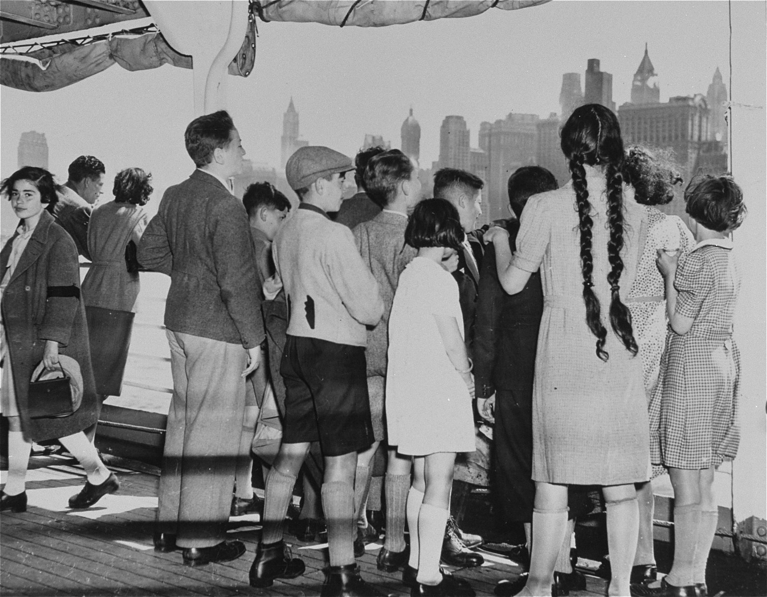 Jewish refugee children are shown on the deck of the SS President Harding looking out at the lower New York skyline.  

The ship carried 50 children who ranged in age from 5 to 15 and went to an estate in Philadelphia to await their parents who were still abroad.
