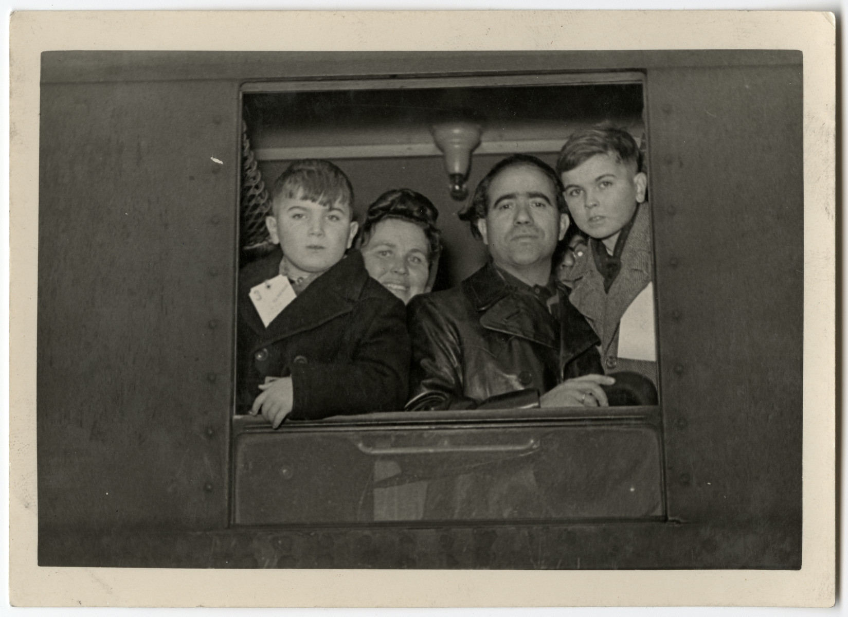 The Galicki family looks out a train window as they leave for the Bremerhaven harbor en route to the United States.

From left to right are Paul, Lydia, Noel and Albert.