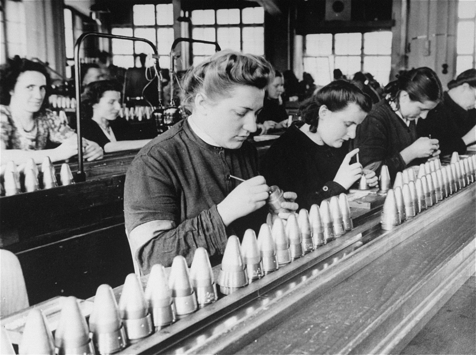 Female foreign workers (in dark clothing) from the Stadelheim prison work in a factory owned by the AGFA camera company.

This photograph was submitted in evidence as part of the case against I.G. Farben.