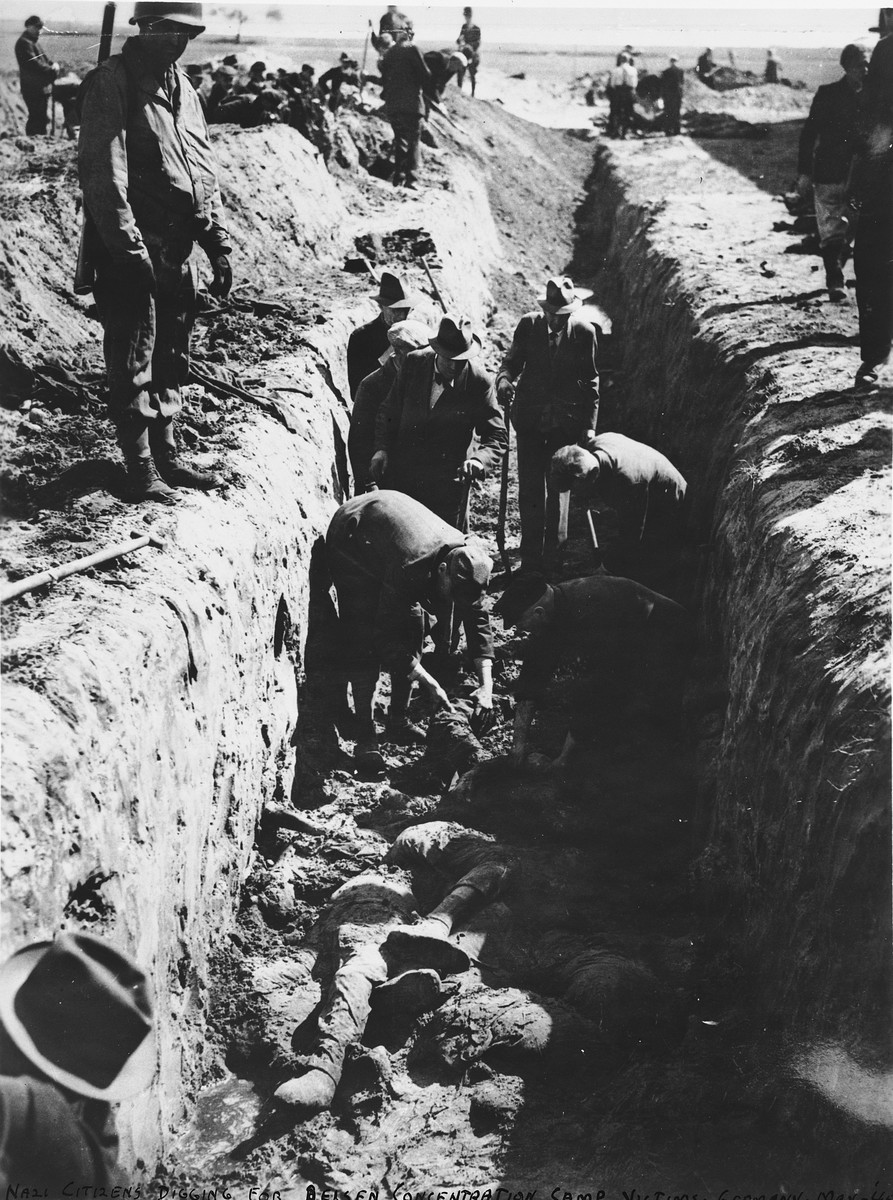 An American soldier oversees German civilians forced to bury corpses in a mass grave.

[Though the caption states that the camp is Bergen-Belsen, the presence of an American soldier and the size of the grave indicates that the original identification may be incorrect.]