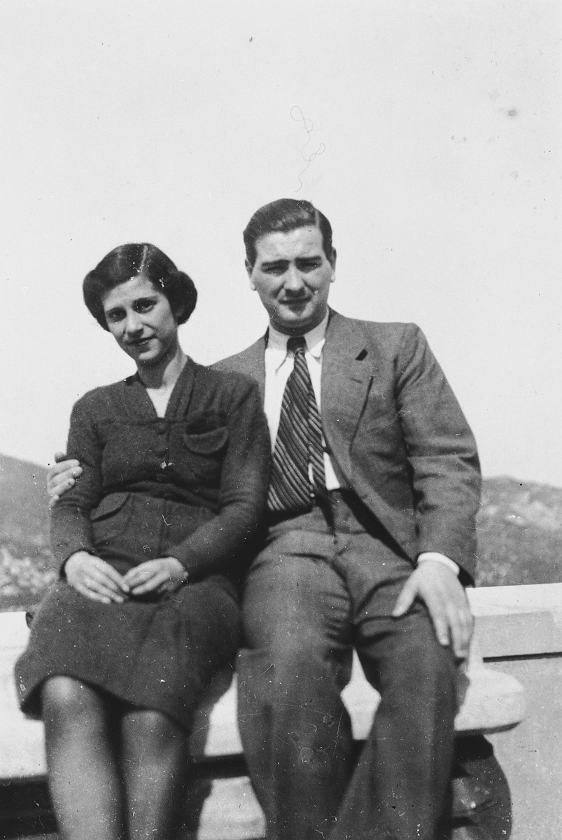 Portrait of Samuel and Liesl Ekerling sitting on an outdoor bench in the United States shortly after they immigrated.  They mailed this photograph back to their parents in Vienna.