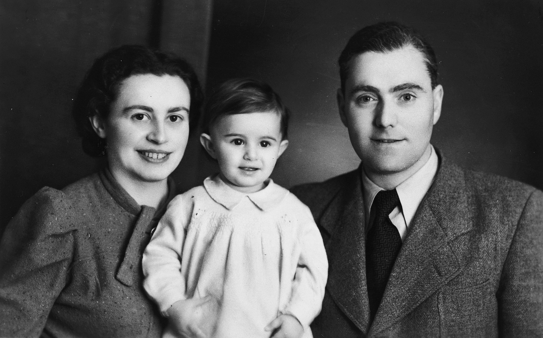 Studio portrait of an Austrian-Jewish couple and their young daughter.

Pictured are Ernst, Paul and Lisl Porges.