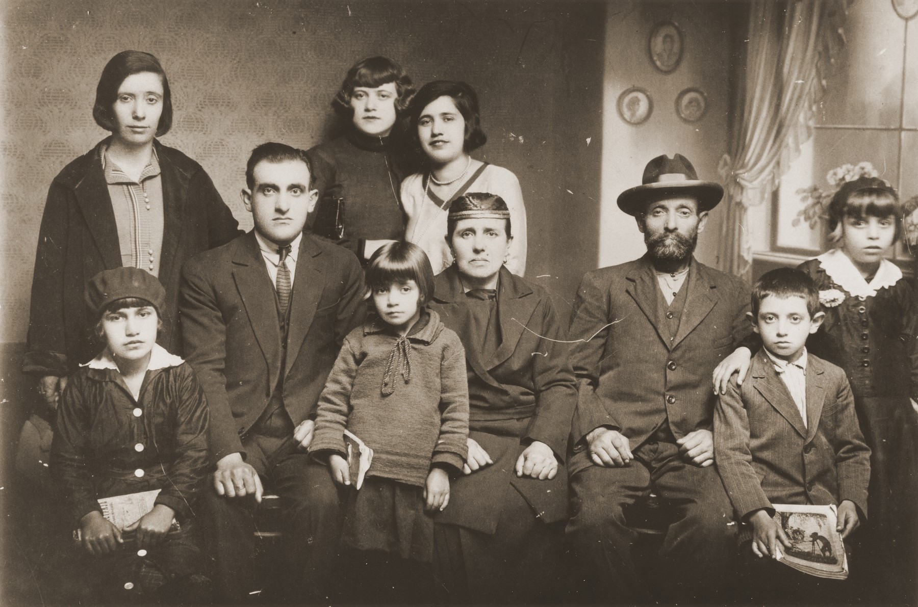 Portrait of the family of Mushon and Rebeka Kamchi in Bitola, Macedonia.

Isak Kamchi is pictured in the front row at the right.