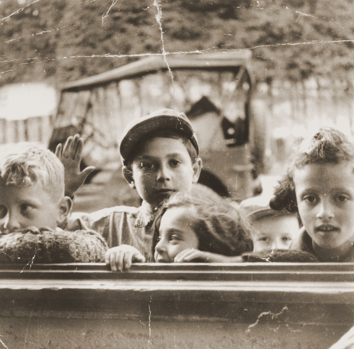 A group of DP children peer in a window at the Feldafing displaced persons camp.