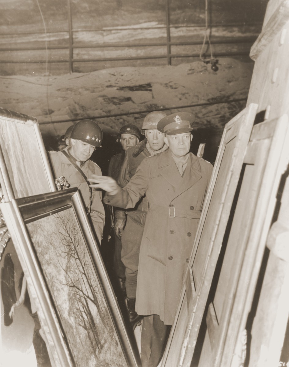 General Dwight D. Eisenhower, Supreme Allied Commander in the West, accompanied by General Omar Bradley (left), and Lt. General George S. Patton, inspect stolen art treasures hidden in the Merkers salt mine.

Also picutred in the center is Major Irving Leonard Moskowitz.