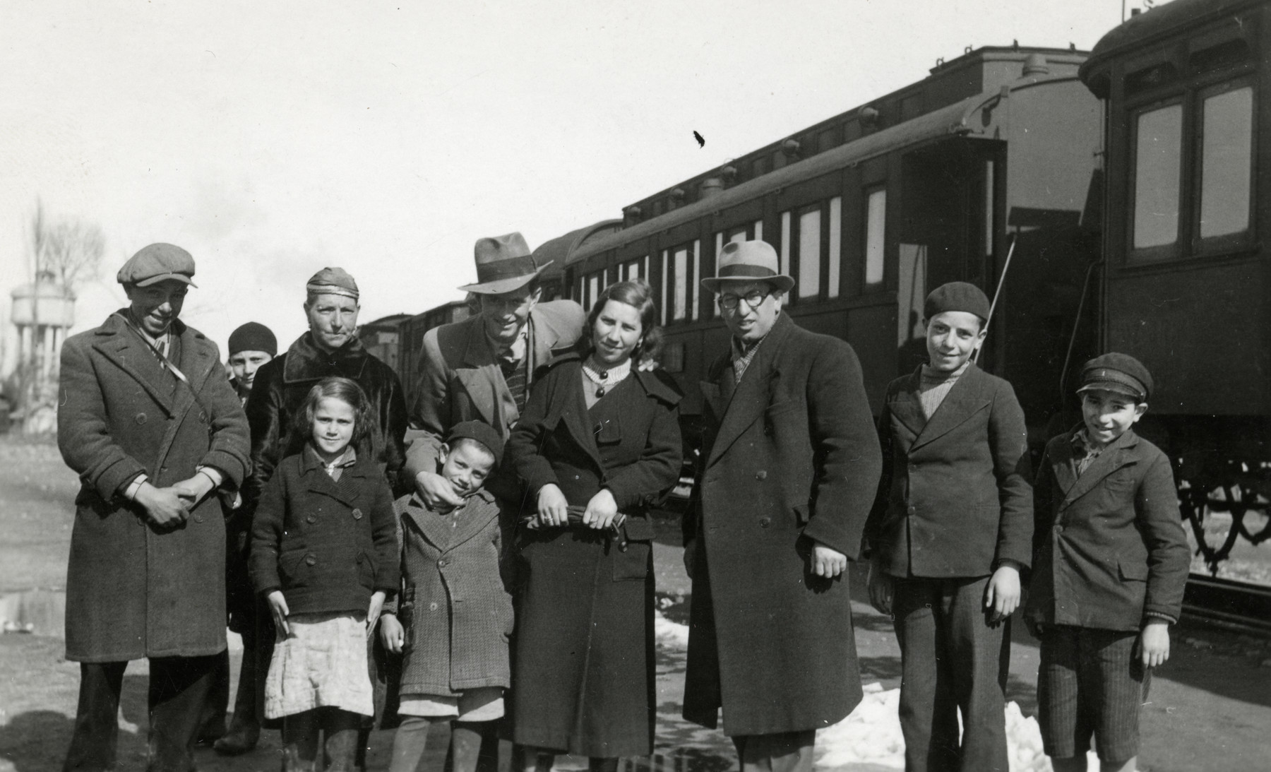 Rabbi Moise Cassorla (father of the donor) poses with his family in front of a train. 

Rabbi Cassorla stands third from the right. His mother stands third from the left.