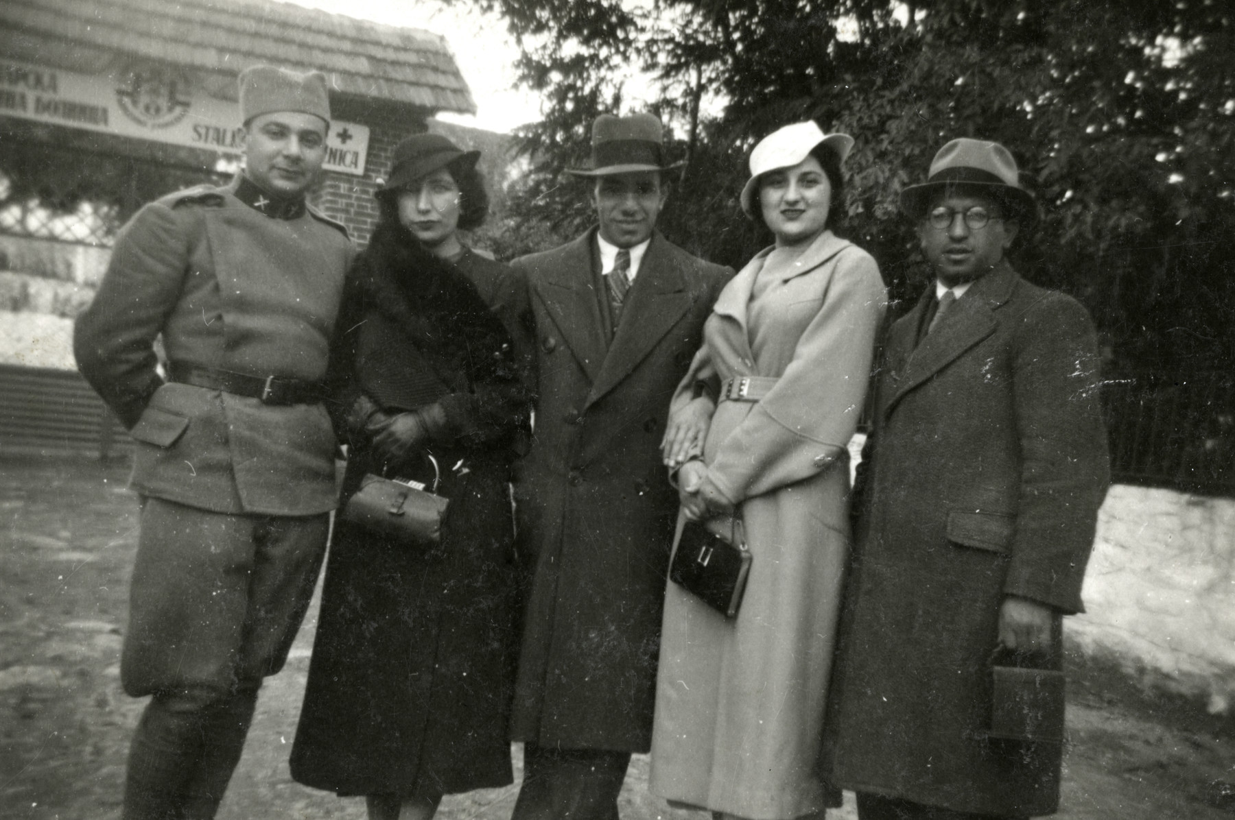 A group of Macedonian Jews poses in front of a hospital.

Pictured are Rabbi Cassorla (father of the donor, on right), his sister, a couple and a man in a uniform (who may be " Joseph Pappo", a Serbian friend)
