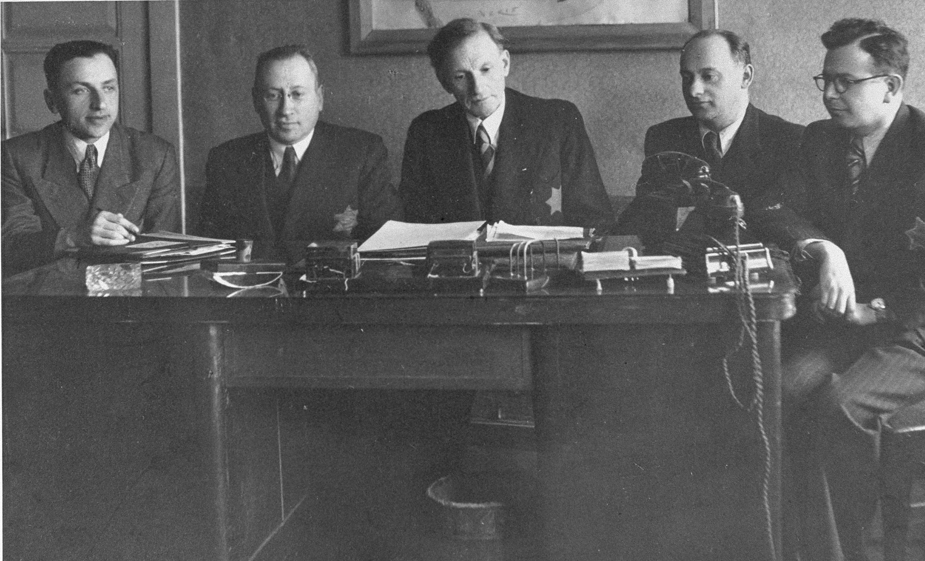 Members of the Kovno Altestenrat (Council of the Elders).

Left to right are Avraham Tory secretary; Leib Garfunkel, deputy chairman; Elkhanan Elkes, chairman; Yakov Goldberg, head of the Labor Office and Zvi Levin, advisor and link with the underground.