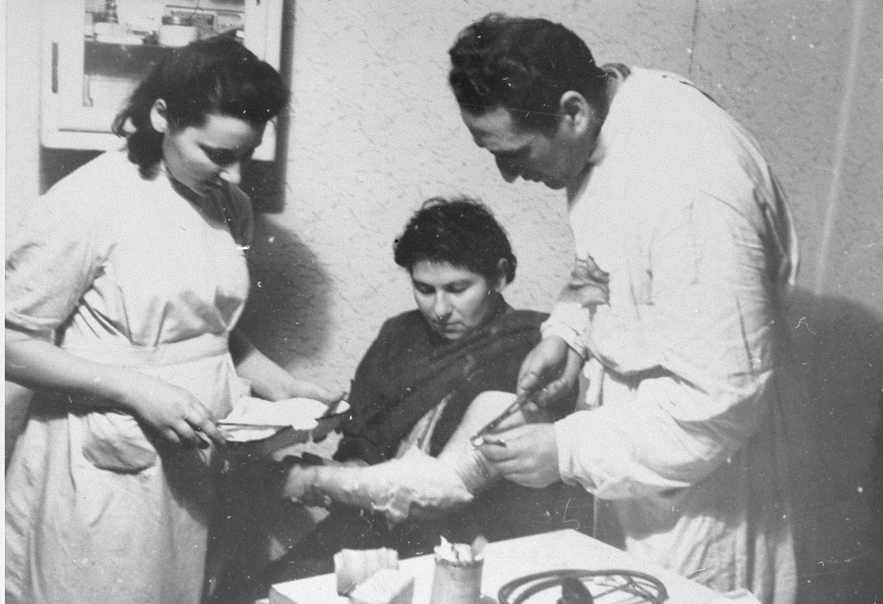 Dr. David Arolianski treats a patient in his clinic in the Kovno ghetto.  

Dr. Aroliansky was killed in a bunker during the ghetto's liquidation, June 1944.