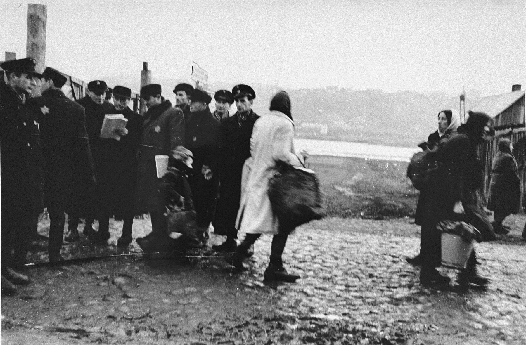 Jewish police gathering at the main gate to the ghetto. Standing first on the left is Avrasha Stupel, who played the violin with the Kovno ghetto orchestra.