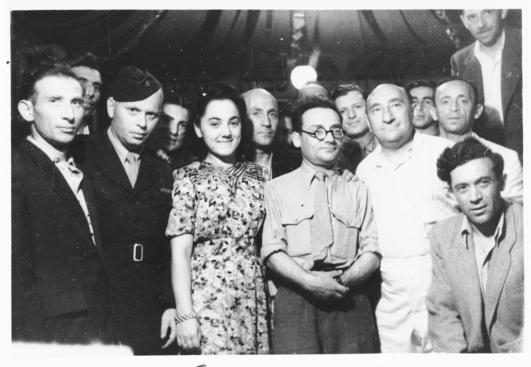Group portrait of Jewish displaced persons in the Pocking camp.

Samuel Tick (the leader of Farband) is on the far left.  His wife Faiga Milchberg Tick is in the center. The gentleman standing in the front, center (wearing glasses) has been identified as Mr. Cyrlak.