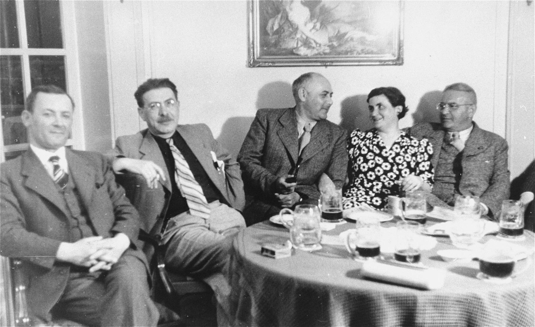 Passengers sit by a table in the dining room of the refugee ship MS St. Louis.   

From a photo album belonging to St. Louis passenger Moritz Schoenberger.