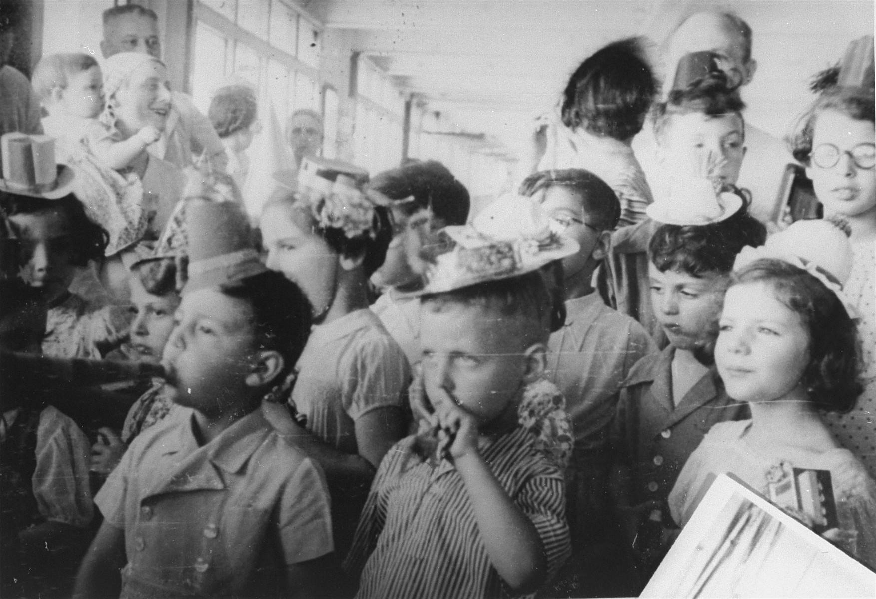 Children's party on board the St. Louis. The boy on the right wearing a small white hat is Rolf Altschul. Directly behind him is Gerd Altschul.  Hildegarde Wolff is in the lower right-hand corner.

Photo from the personal St. Louis photo album assembled by the donor's mother, Lotte Altschul.