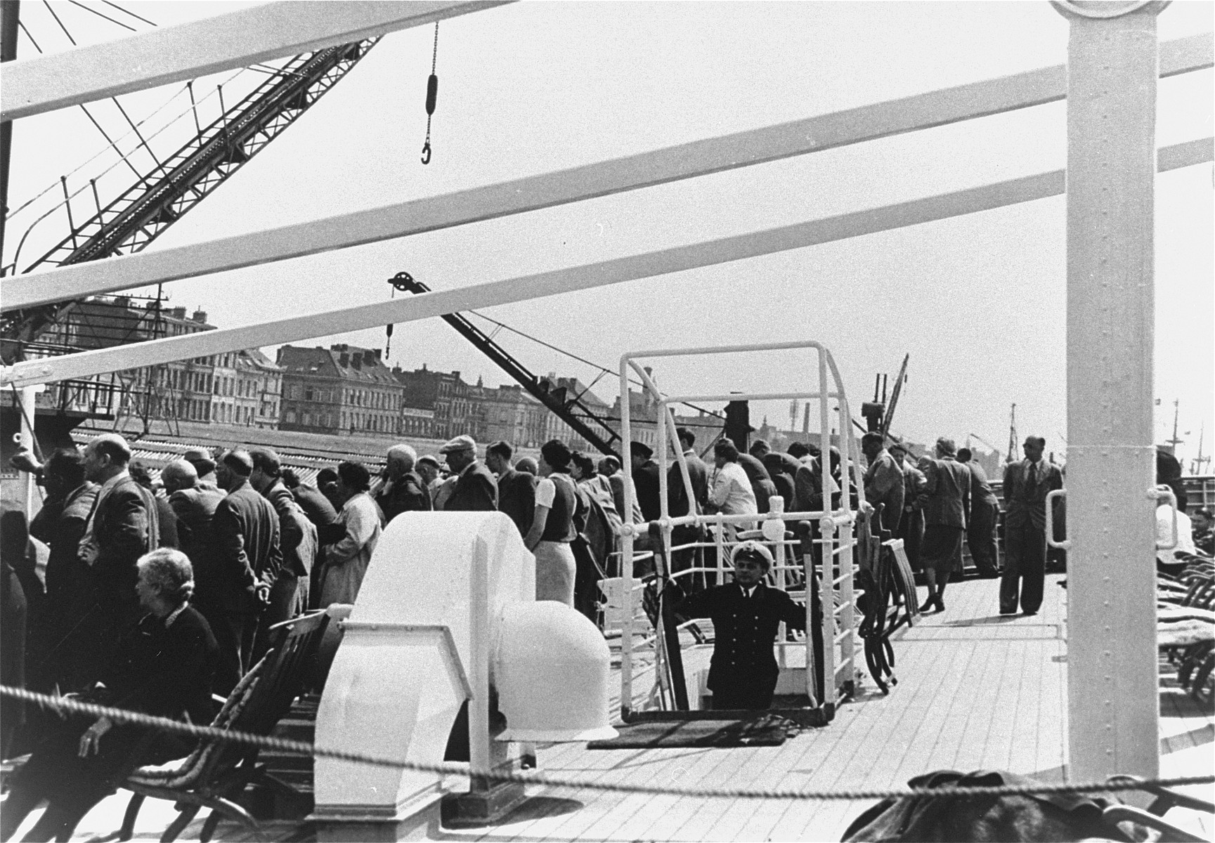 Passengers stand on the deck as the refugee ship the MS St. Louis arrives in the port of Antwerp.