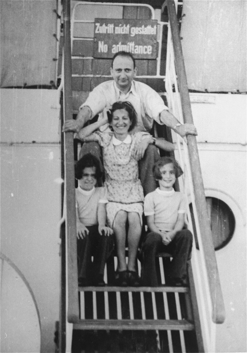 Fritz, Babette, Renate and Ines Spanier pose on a stairwell on the MS St. Louis in front of a sign that reads "no admittance".