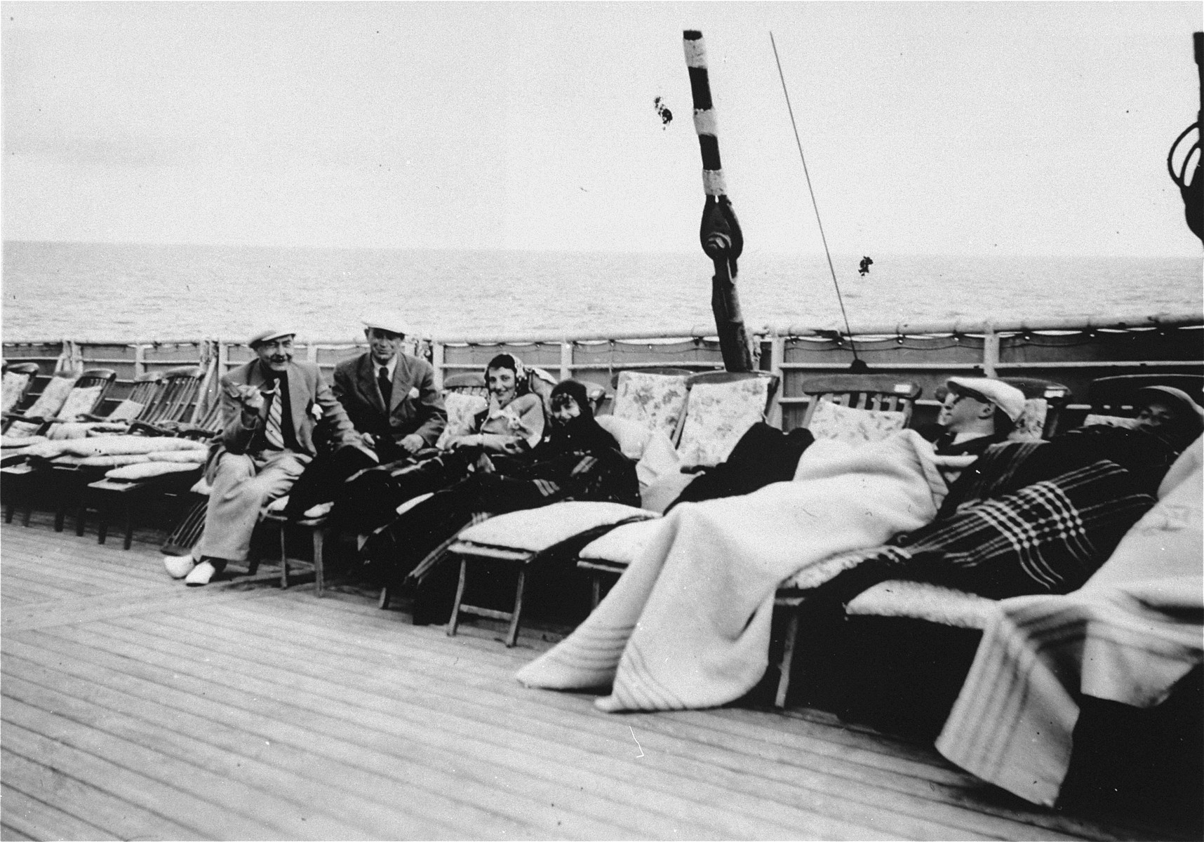 Passengers lounge on the deck of the refugee ship MS St. Louis.   

From a photo album belonging to St. Louis passenger Moritz Schoenberger.