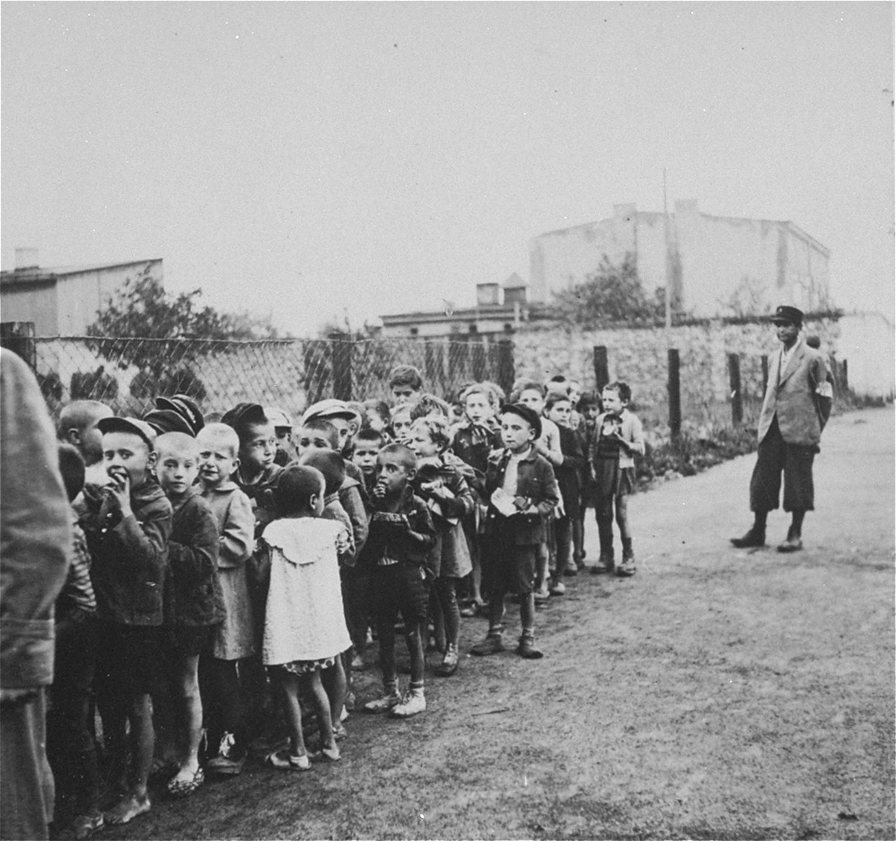 Children from the Marysin colony who were rounded-up during the "Gehsperre" action in the Lodz ghetto, march in a long column towards a deportation assembly point.