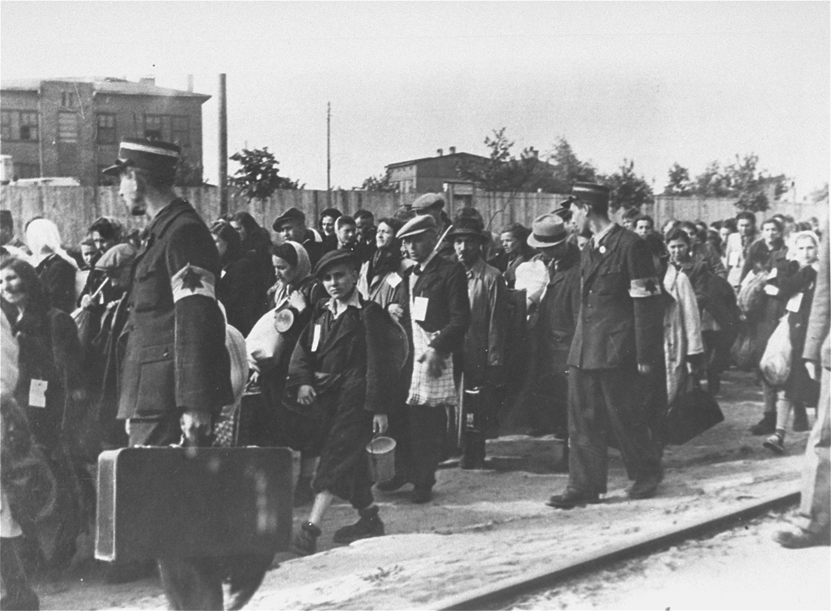 Jewish police escort a group of Jews who have been rounded-up for deportation in the Lodz ghetto.