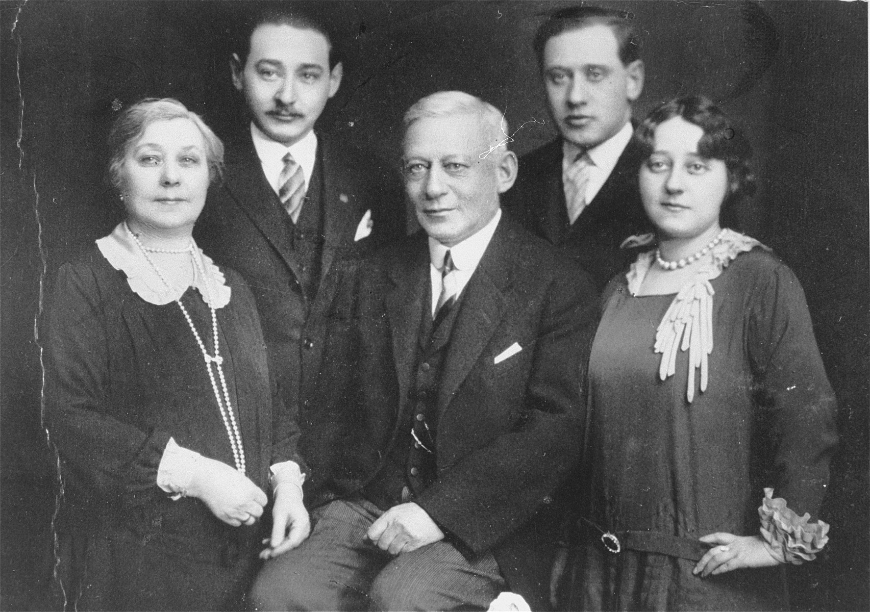 Portrait of Samu and Malvina Kornhauser with their three children, taken on the occasion of their twenty-fifth wedding anniversary.  

Pictured in the front row from left to right are: Malvina Kornhauser, Samu Kornhauser and Margit Kornhauser.  Behind them from left to right, are Laszlo Kornhauser and Karoly Kornhauser.