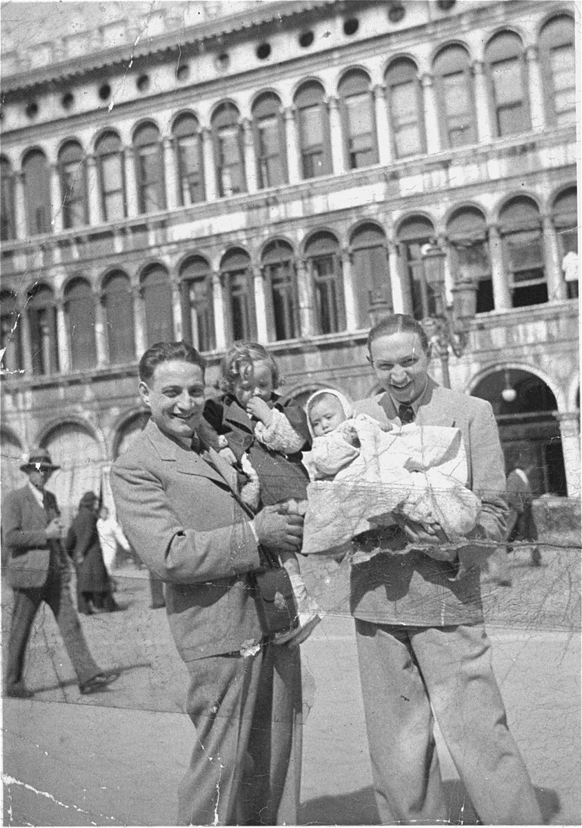 Two Jewish brothers on vacation in Italy.  

Pictured at the left is Paul Barber with his child, and at the right, Gyorgy Barber with his infant.  Paul and Gyorgy Barber are the uncles of Karoly Barber.