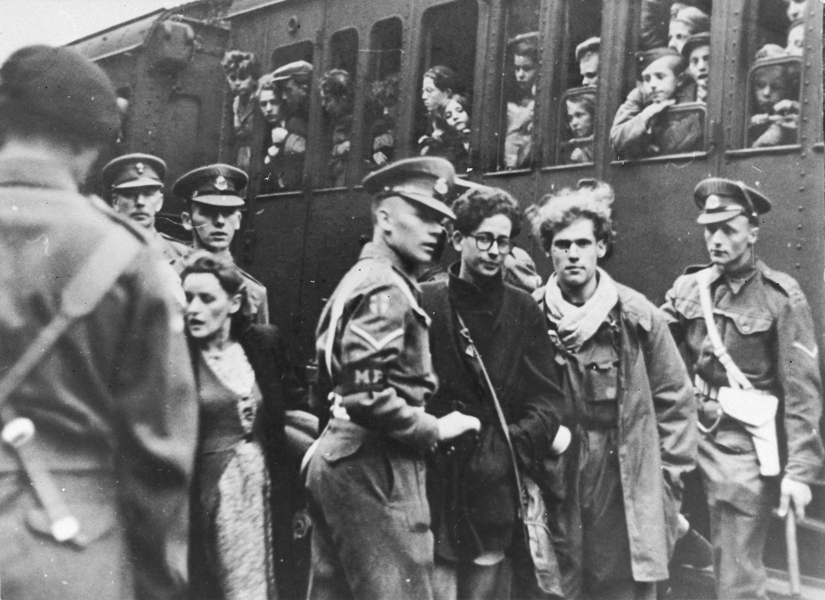 British police escort two former passengers of the Exodus 1947 who were brought back to Europe, at the train station in Hamburg.

Pictured are Benno Ginsburg (right) and Jacques Rabinovich (left, wearing glasses).
