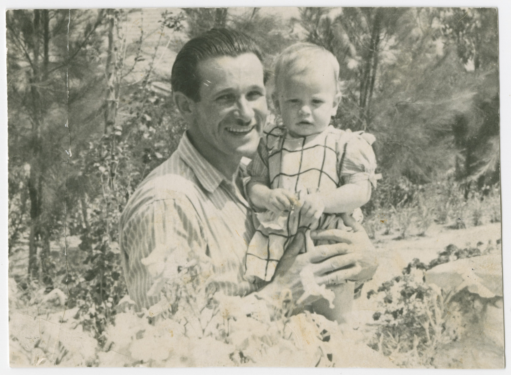 Yehuda Bielski holds his baby daughter Nili.