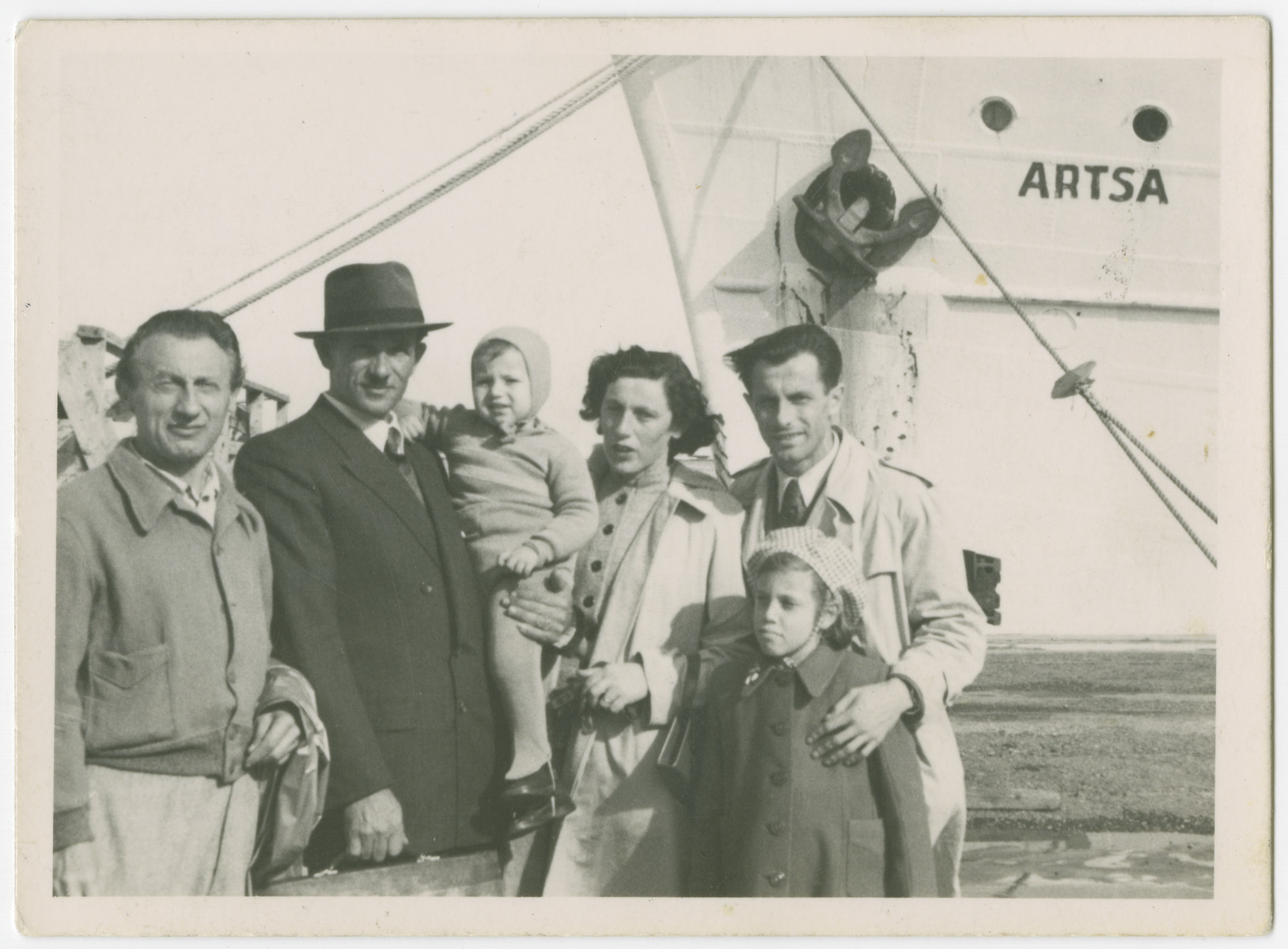 The family of Yehuda Bielski prepares to sail from Israel to the United States.

From left to right are Marcus Hudes (unlce of Lola), Yehuda holding his son Yigal, Lola, and Eli Hudes (Lola's brother).  Nili Bielski is in front of him.