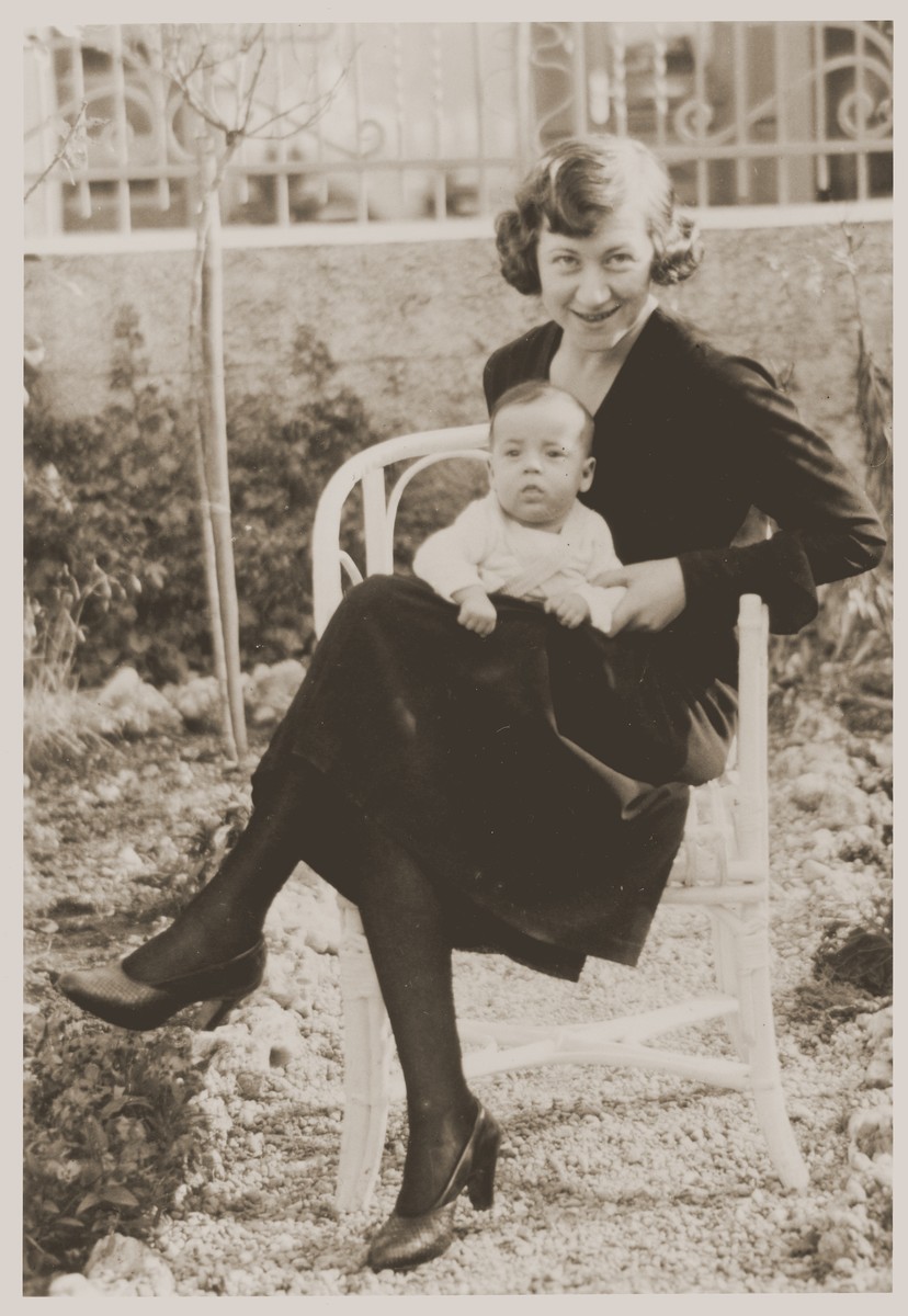 Kate Grunbaum holds her infant daughter Suse outside the home of her mother.