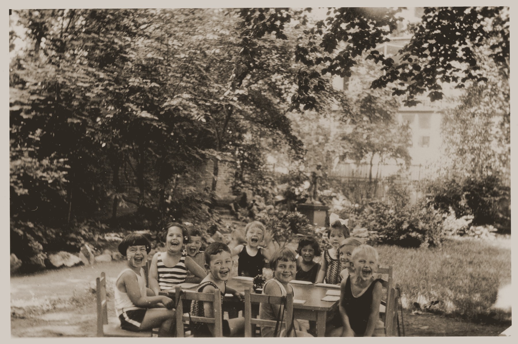 Lore Gotthelf (second from the left) with her classmates at nursery school.

Also pictured is Gunther Alfred Hess (seated in front of the table, center).