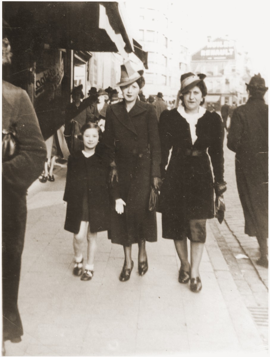 Esther Rosenbaum (middle) walks along a commercial street in Antwerp with her daughter, Frida, and a friend.