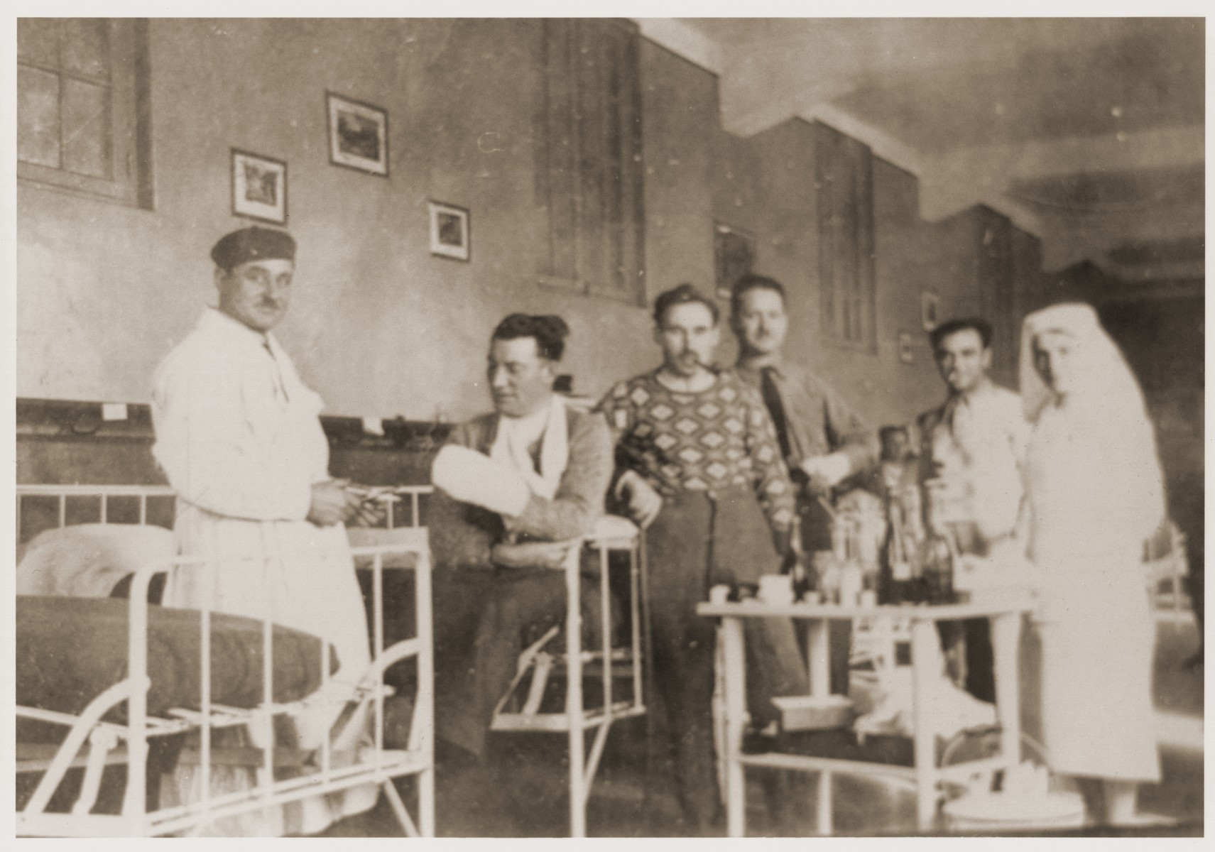 View of patients inside the Noe Hospital. 

Isabelle Peloux, the aunt of Marie Genevieve Parmentier, is at the right.  The original inscription on the back reads: "A souvenir of your good care."

Marie Genevieve Parmentier was a ten year-old French girl living in Paris at the time of the German occupation in 1940. Her widowed mother sent her to safety with an old relative in Ariège in the South of France. She sooned joined her aunt, Isabelle Peloux, a military nurse, at the camp of Recebedou. While there she attended primary school at nearby Portet-sur-Garonne, before returning to her family in the summer of 1941.